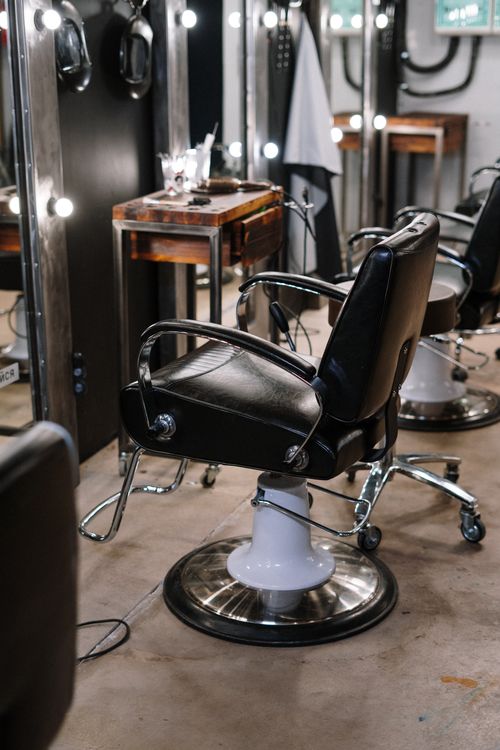 Row of classic barber chairs in front of mirrors